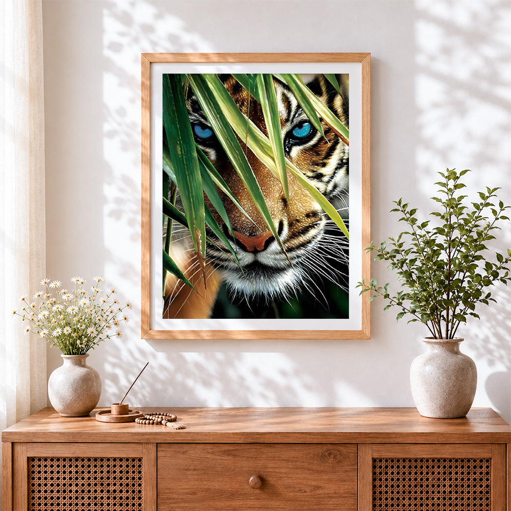 Finished teal eyed tiger and bamboo cross stitch artwork displayed