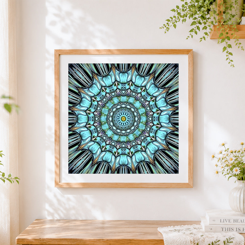 Finished teal kaleidoscope mandala cross stitch artwork displayed
