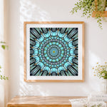 Finished teal kaleidoscope mandala cross stitch artwork displayed