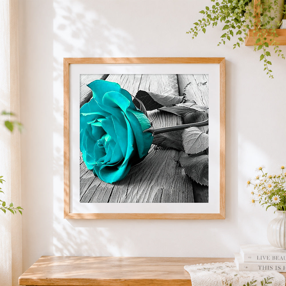 Finished teal rose on wooden board paint by numbers artwork displayed as home decor