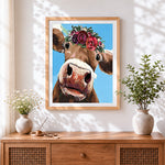 Finished the curious cow with flower crown cross stitch artwork displayed