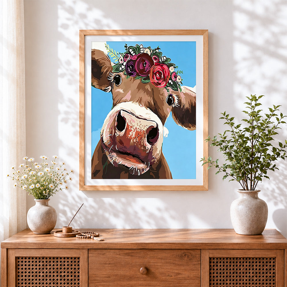 Finished the curious cow with flower crown cross stitch artwork displayed