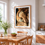 The facepalming lion cross stitch artwork displayed on wall as home decor