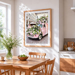 The flower filled car cross stitch artwork displayed on wall as home decor