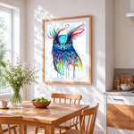 The owl's fiery gaze cross stitch artwork displayed on wall as home decor