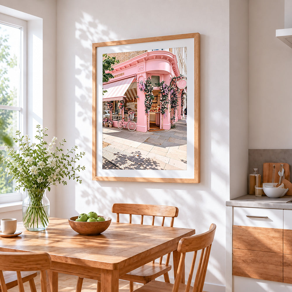 The pink corner shop cross stitch artwork displayed on wall as home decor