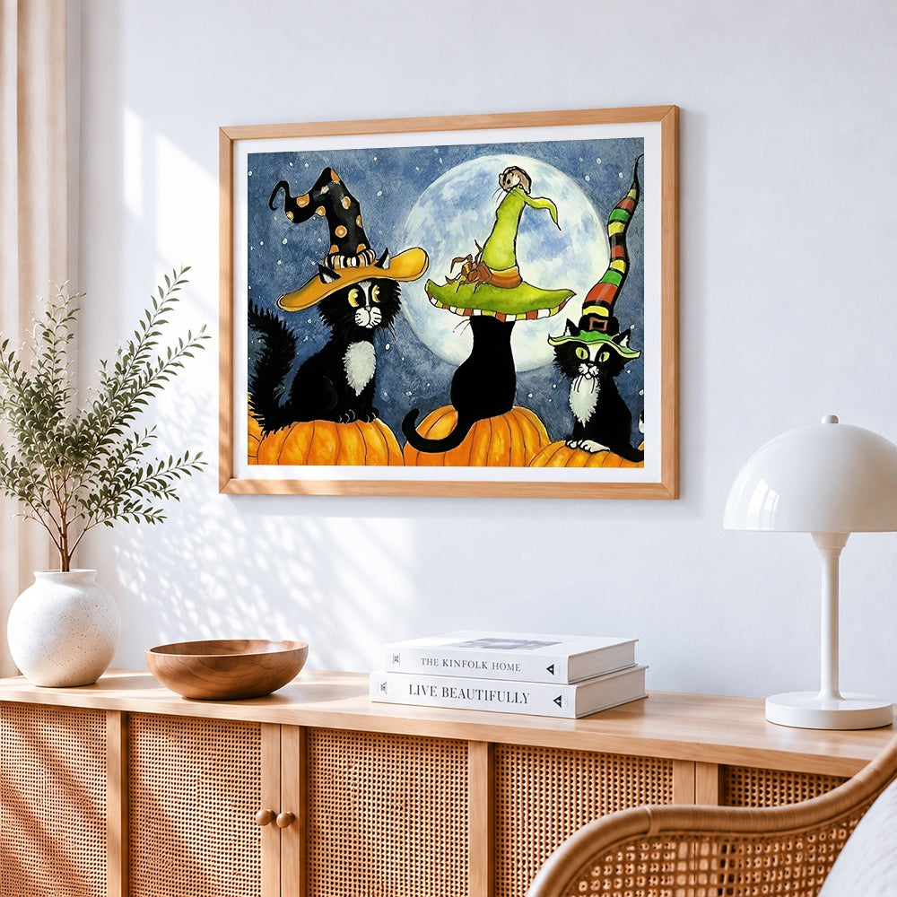 Three black cats in witch hats on pumpkins paint by numbers artwork displayed on wall as home decor