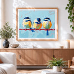 Finished three blue birds on a branch paint by numbers artwork displayed as home decor