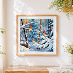 Finished three cardinals in a winter woodland cross stitch artwork displayed