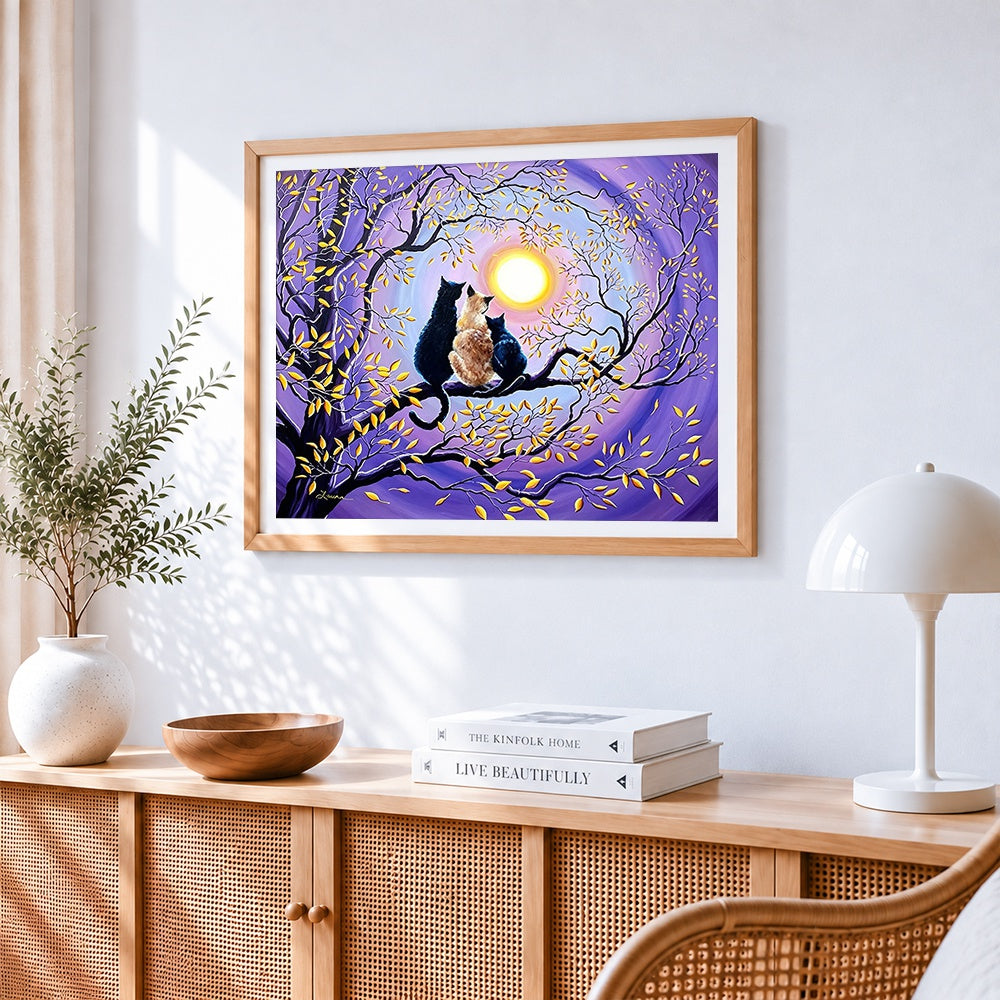 Three cats sitting on a branch cross stitch artwork displayed on wall as home decor
