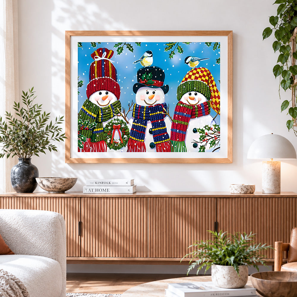 Finished three cheerful snowmen in knitted hats cross stitch artwork displayed