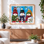 Finished three cheerful snowmen in knitted hats paint by numbers artwork displayed as home decor