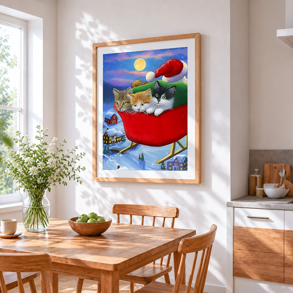 Three cute kittens in a sleigh cross stitch artwork displayed on wall as home decor
