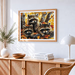 Three cute raccoons in autumn leaves cross stitch artwork displayed on wall as home decor