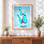 Finished three glowing blue butterflies over water cross stitch artwork displayed