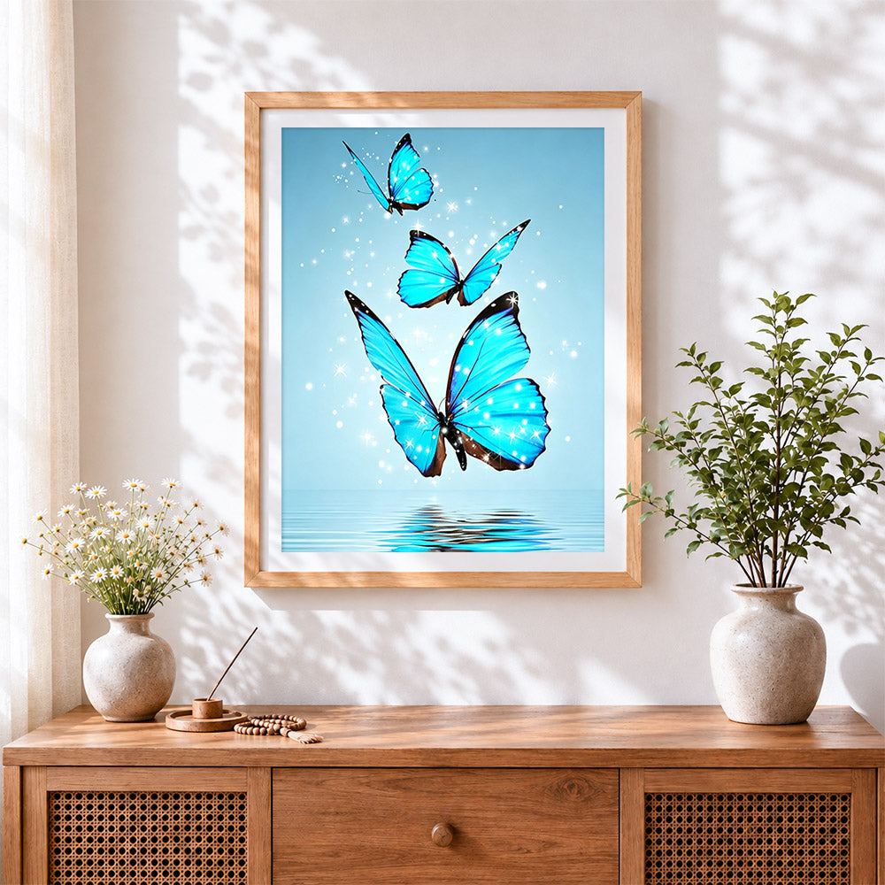 Finished three glowing blue butterflies over water cross stitch artwork displayed