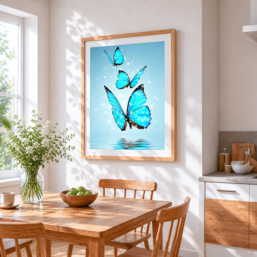 Three glowing blue butterflies over water cross stitch artwork displayed on wall as home decor