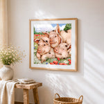 Three sleeping pigs in flowers cross stitch artwork displayed on wall as home decor