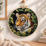 Tiger among green leaves embroidery hoop wall art displayed as warm and cosy handmade home decor