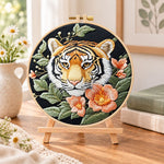 Tiger and peach blossoms embroidery kit finished hoop displayed on a wooden stand as cosy tabletop decor