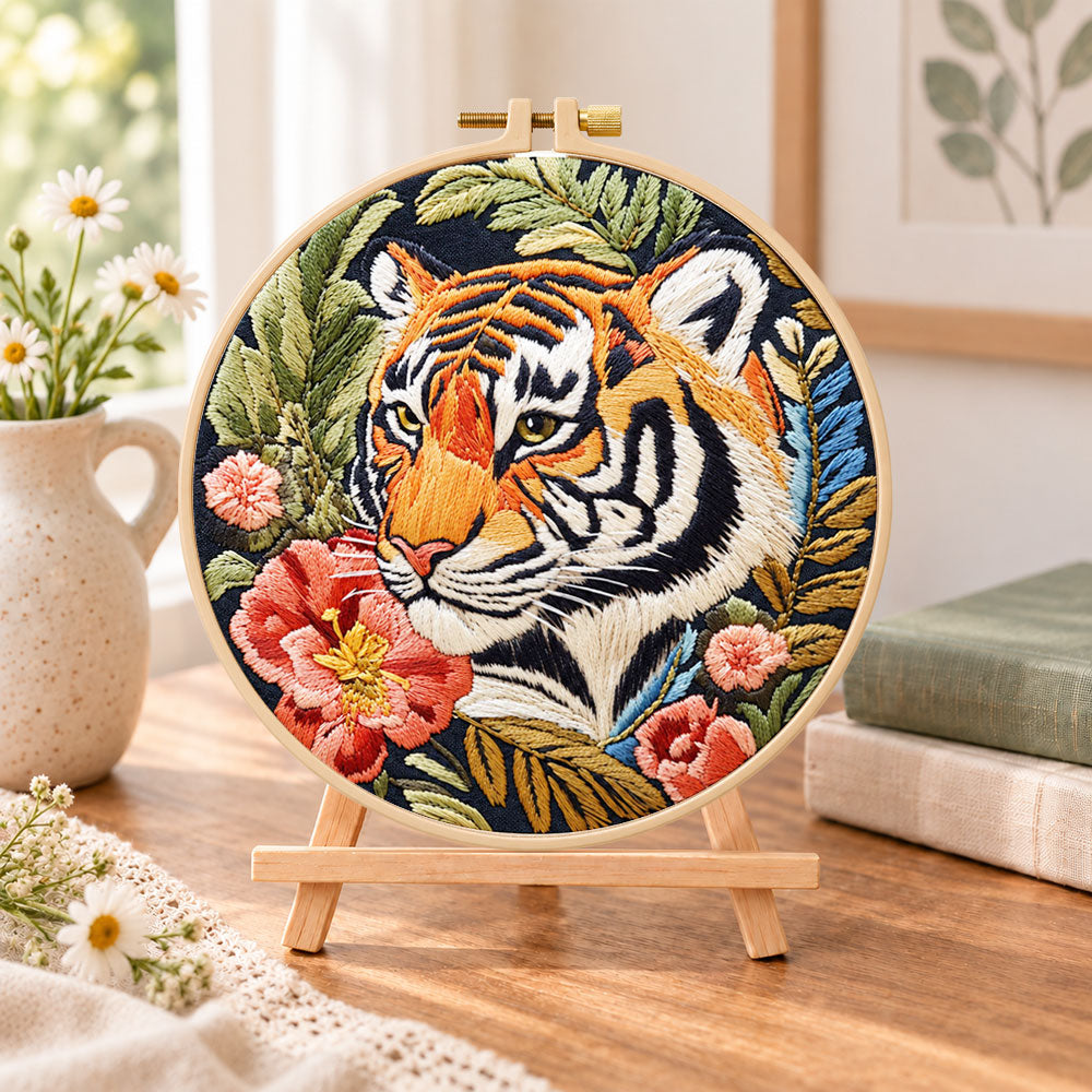 Tiger and red peonies embroidery kit finished hoop displayed on a wooden stand as cosy tabletop decor