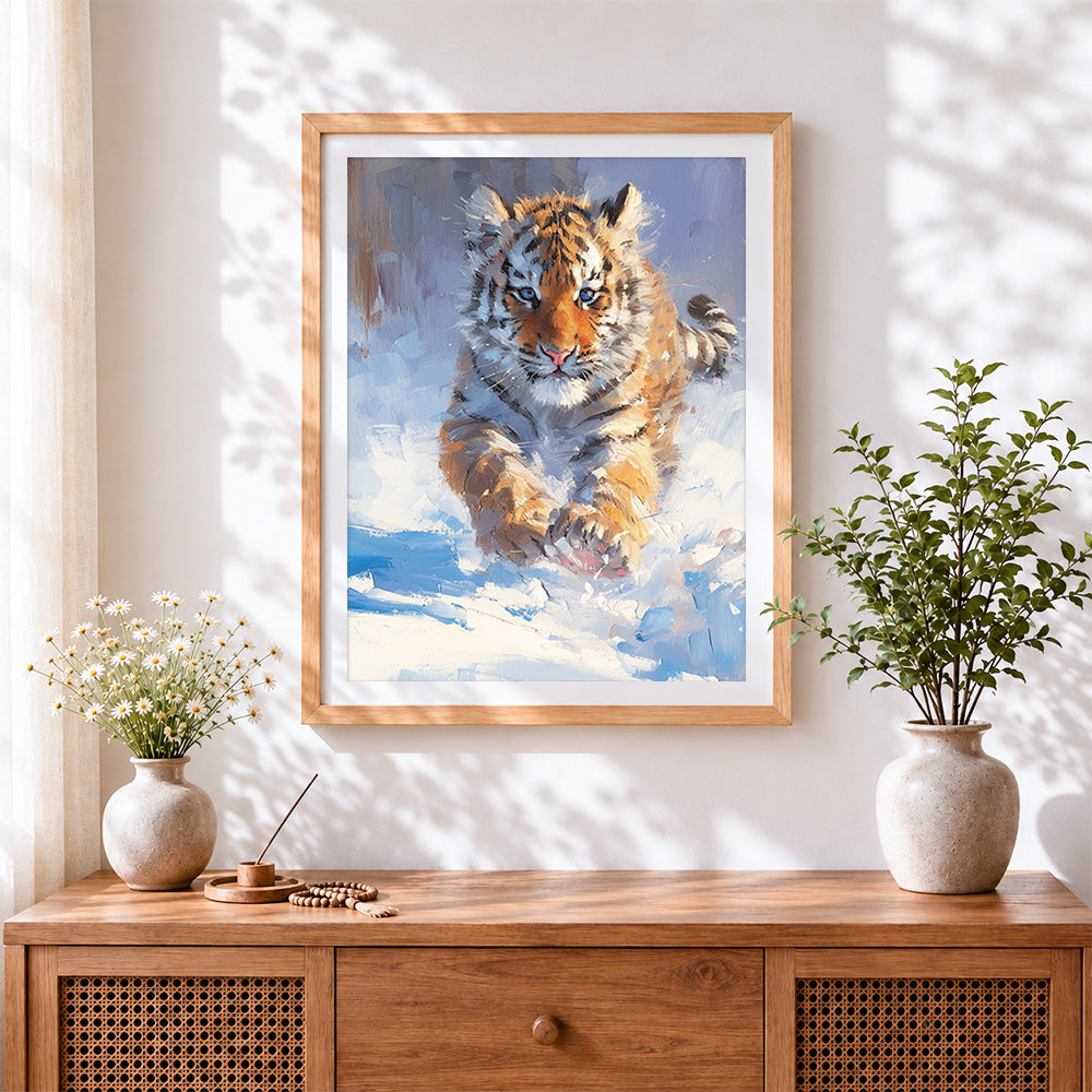 Finished tiger cub in snow cross stitch artwork displayed