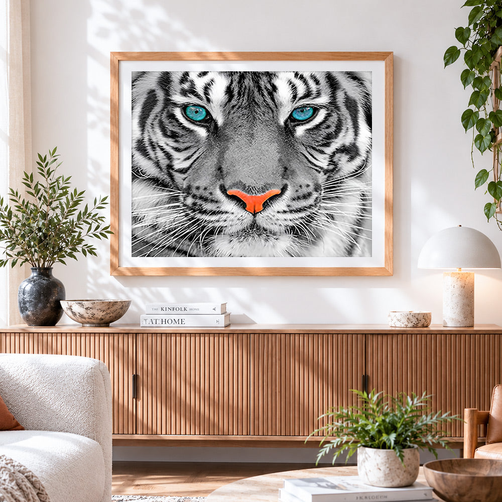 Finished tiger face close-up cross stitch artwork displayed