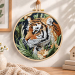 Tiger in jungle foliage embroidery hoop wall art displayed as warm and cosy handmade home decor