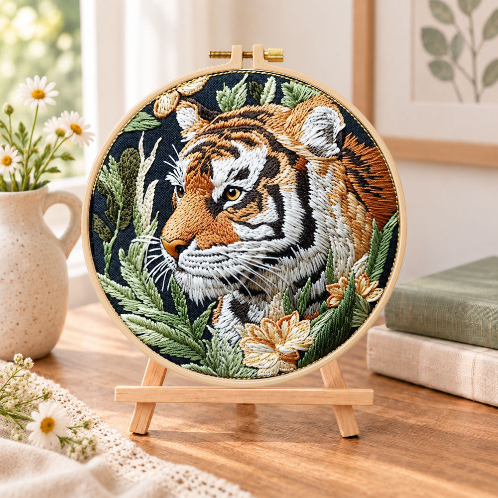 Tiger in jungle foliage embroidery kit finished hoop displayed on a wooden stand as cosy tabletop decor
