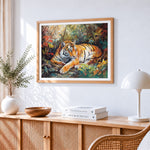 Tiger resting in autumn leaves cross stitch artwork displayed on wall as home decor