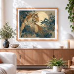 Finished tiger resting on a tree branch with full moon cross stitch artwork displayed