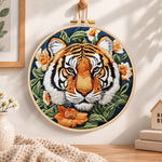 Tiger surrounded by blooms embroidery hoop wall art displayed as warm and cosy handmade home decor