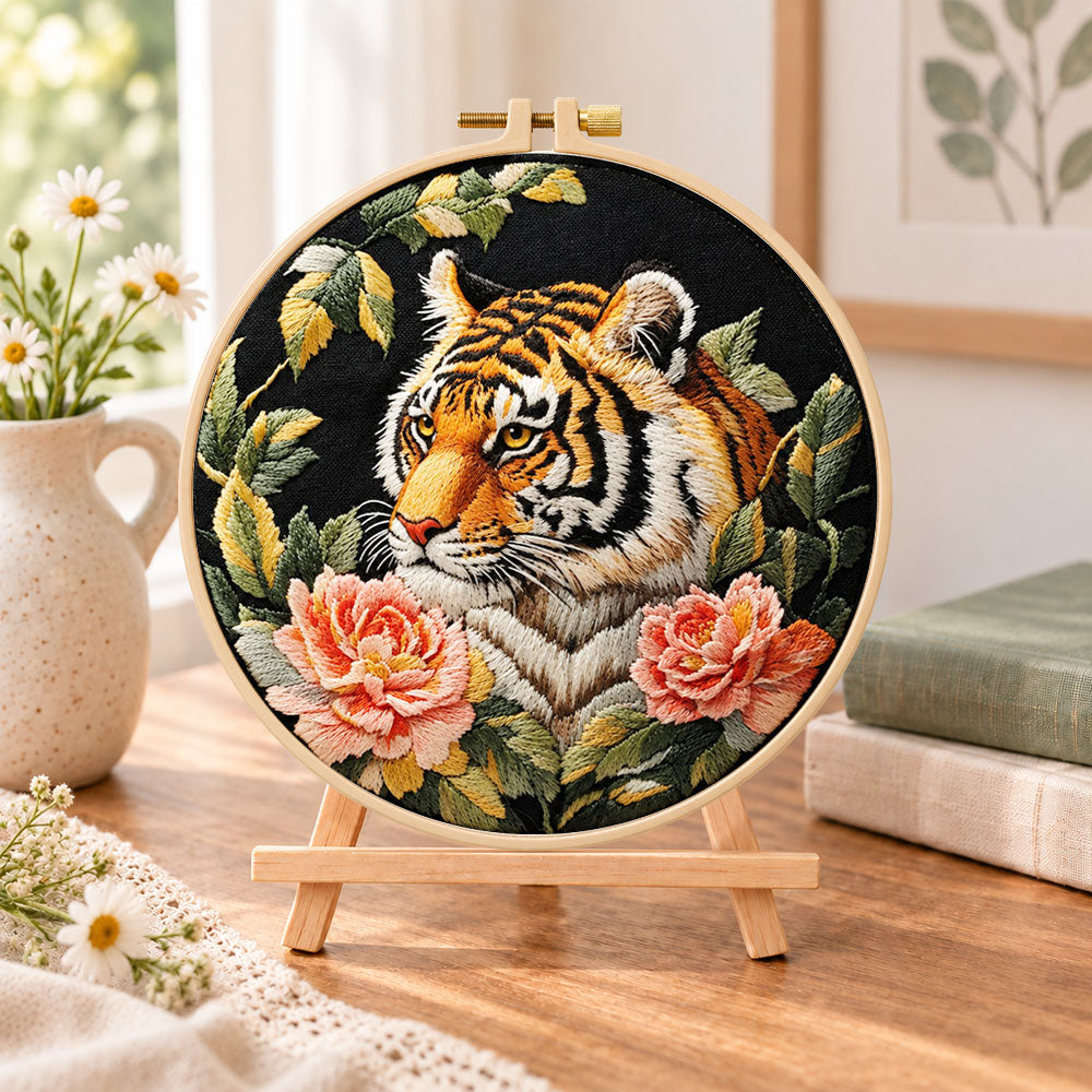 Tiger with pink peonies embroidery kit finished hoop displayed on a wooden stand as cosy tabletop decor
