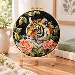 Tiger with pink peonies embroidery kit finished hoop displayed on a wooden stand as cosy tabletop decor