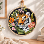 Tiger with wild blooms embroidery hoop wall art displayed as warm and cosy handmade home decor