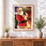 Finished traditional smiling santa with green sack cross stitch artwork displayed