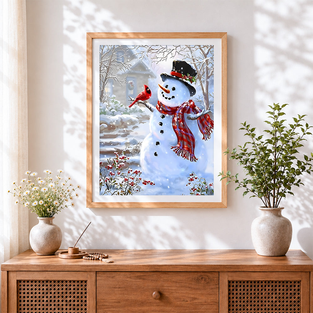 Finished traditional snowman and red cardinal in the snow cross stitch artwork displayed