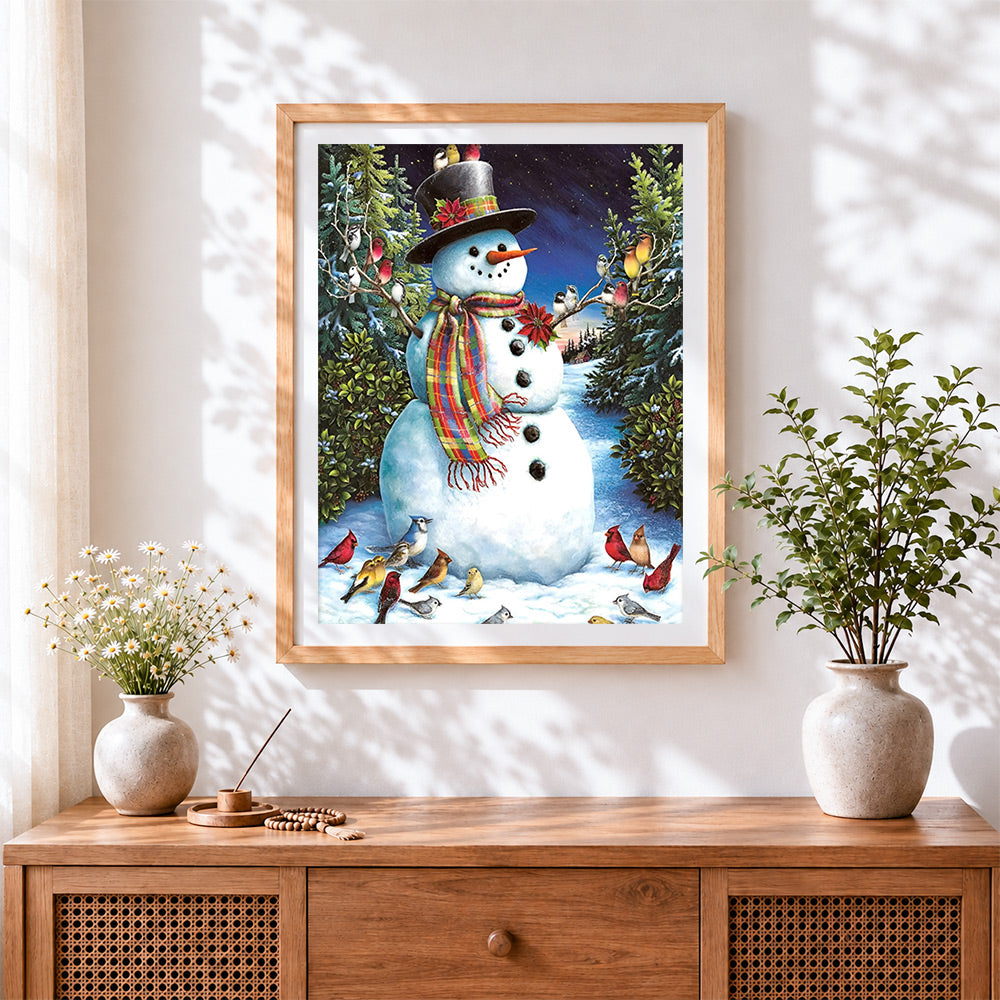 Finished traditional snowman and winter birds cross stitch artwork displayed