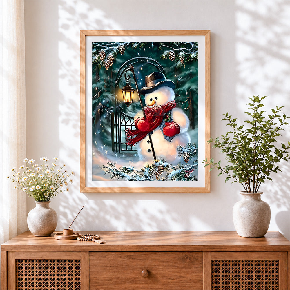 Finished traditional snowman with lantern in a winter forest cross stitch artwork displayed