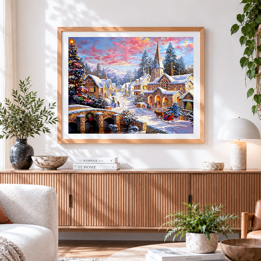 Finished traditional snowy village and church cross stitch artwork displayed