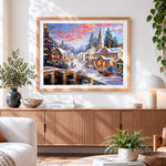 Finished traditional snowy village and church cross stitch artwork displayed