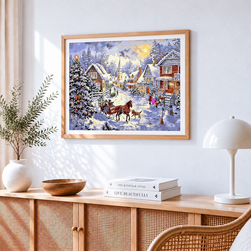 Traditional snowy village with horse-drawn sleigh cross stitch artwork displayed on wall as home decor