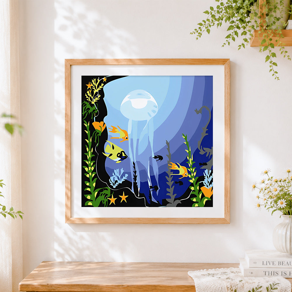 Finished transparent jellyfish and tropical fish cross stitch artwork displayed