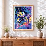 Finished tropical fish in a coral reef cross stitch artwork displayed