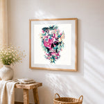 Tropical floral skull with parrots cross stitch artwork displayed on wall as home decor