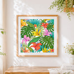 Finished tropical flowers and monstera pattern cross stitch artwork displayed