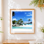 Finished tropical lagoon resort cross stitch artwork displayed