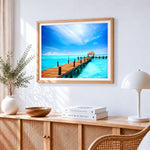 Tropical pier with thatched hut cross stitch artwork displayed on wall as home decor