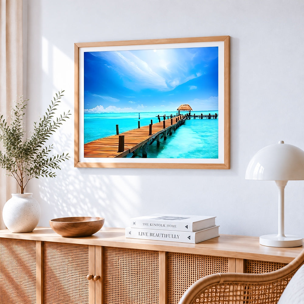 Tropical pier with thatched hut cross stitch artwork displayed on wall as home decor