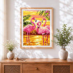 Finished tropical pink flamingos at sunset cross stitch artwork displayed